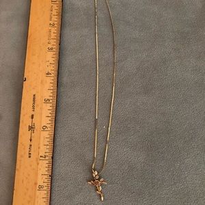 Gold tone necklace with flower cross